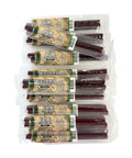 Multiple packages of beef sticks with a mixture of different flavors like Original, Teriyaki and Cheese and Peppers on a white background