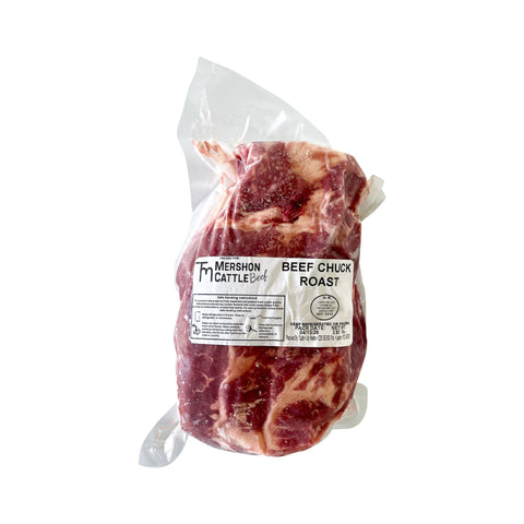 Raw beef chuck roast in a clear plastic bag with a label on a white background