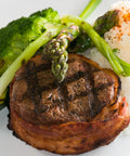 Grilled steak with vegetables and rice on a white plate