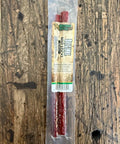 Packaged beef stick on a wooden surface