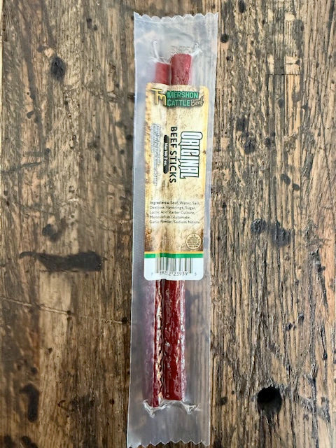 Packaged beef stick on a wooden surface