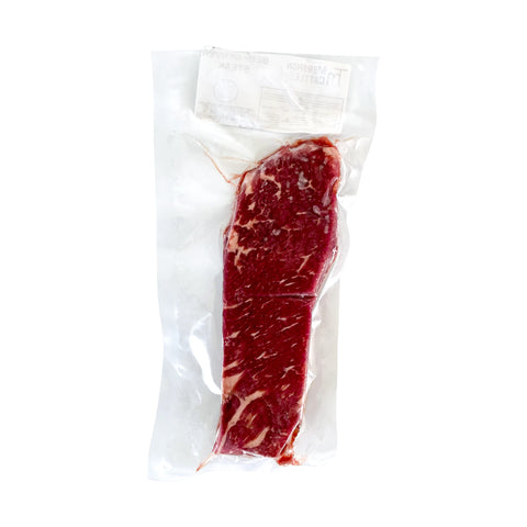 Vacuum-sealed raw steak on a white background