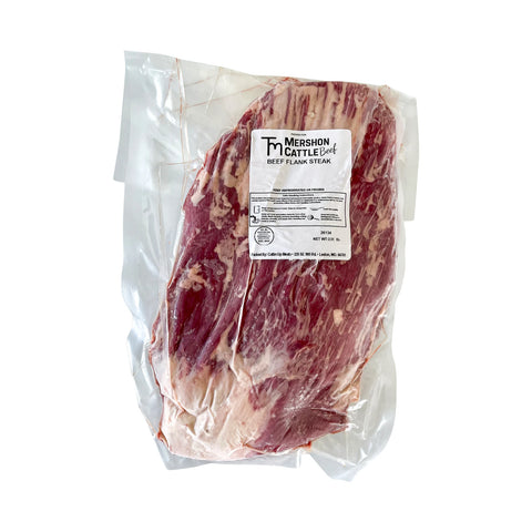 Packaged beef flank steak with a label on a white background