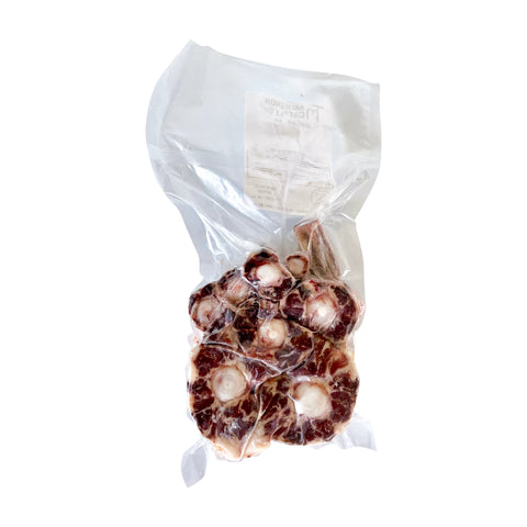 Packaged meat products in a clear plastic bag on a white background