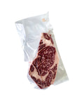 Vacuum-sealed steak on a white background