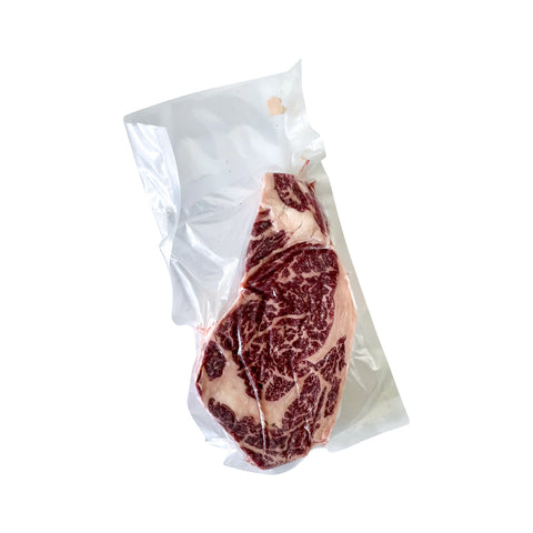 Vacuum-sealed steak on a white background