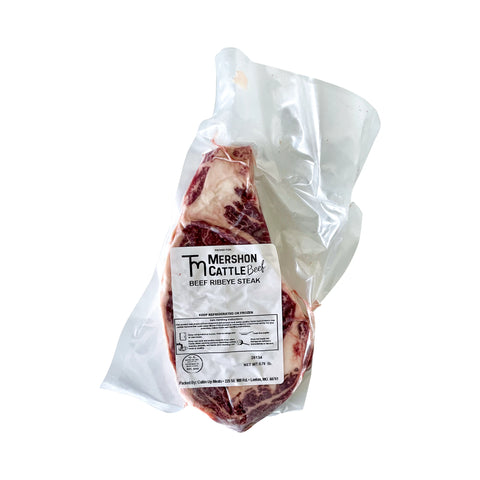 Packaged beef ribeye steak with Mershon Cattle label on a white background