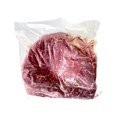 Raw meat in a clear plastic bag on a white background