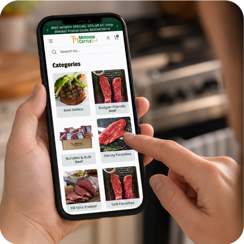 Person holding a smartphone displaying the Merson Cattle Company app with categories of beef.