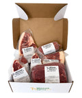 An open white and brown cardboard box filled with packaged beef cuts from Mershon Cattle Co., including a ribeye roast, tenderloin, chuck roast, and steaks, photographed on a white background.