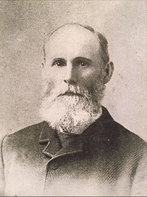 Black and white portrait of a man with a beard and formal attire