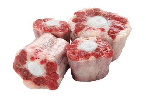 Two raw meat bones on a white background